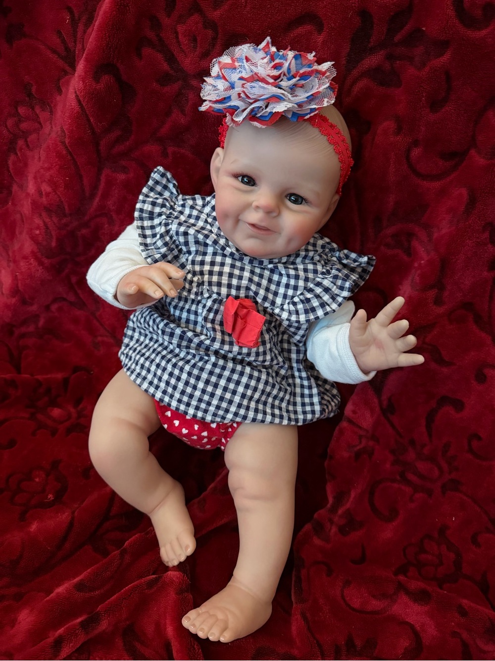 Realistic Baby Girl Doll in Pink Plaid Outfit with White Headband